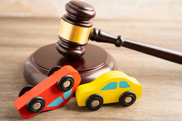 Hammer gavel judge with car vehicle accident, insurance coverage claim lawsuit court case.