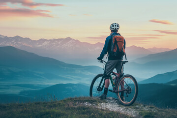 Naklejka premium A man is riding a bike on a mountain top