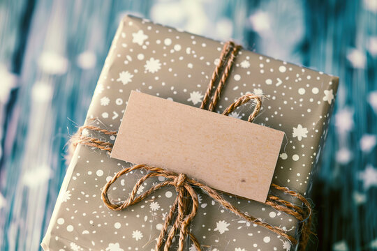 Gift package with a blank tag on a blue background.