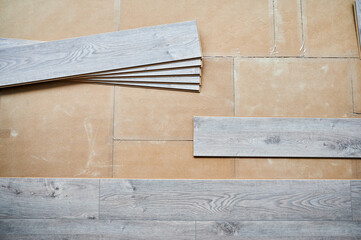 Floor underlayment with wooden flooring boards for home renovation, construction works and interior architecture. Laminate planks with pattern and wood texture for flooring and interior design.