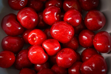 Cherries in a bowl. Close-up. Cherry tree. Cherry tree. View from above. Wallpaper. Background
