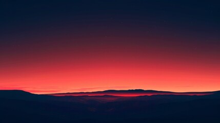 A vibrant sunset over a mountainous horizon
