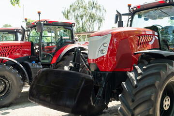 Row of red agricultural tractors for sale.