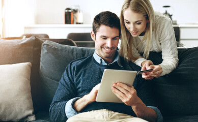Couple, tablet and credit card on sofa for online shopping, bills or banking with fintech app in...