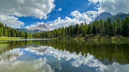 italian alps dolomites national park lake mountain trekking peaks tre cime brais lake carezza lake reflection clouds
