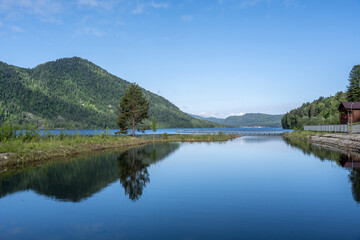 typical summer landscape with mountains, lake and forest in the area of ​​Lake Teletskoye in Altai