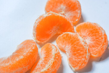 Isolated fresh peeled orange fruit colored orange and yellow. White background
