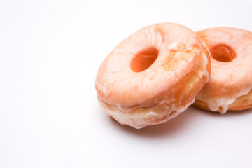 Two donuts placed on a white background