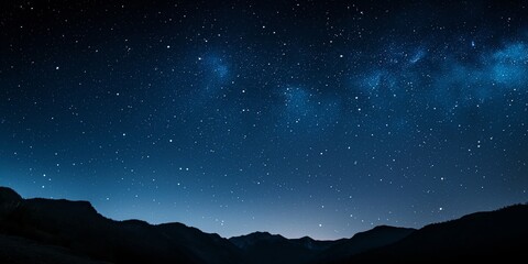 Fototapeta premium Pristine night sky with a glittering array of stars above silhouetted mountain peaks