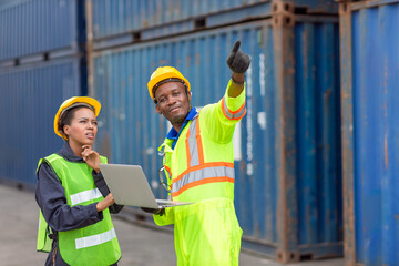 African Black Worker Teamwork in Cargo Port Shipping Industrial in Yellow Hard Hat Safety Vest on Duty. Foreman or Supervisor in Container Ship Yard Terminal.