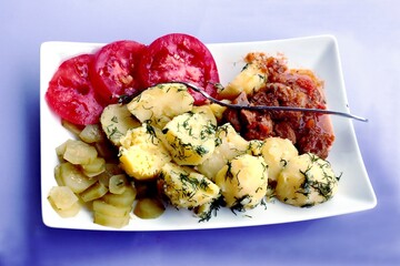 meat goulash with potatoes and vegetables as dinner dish