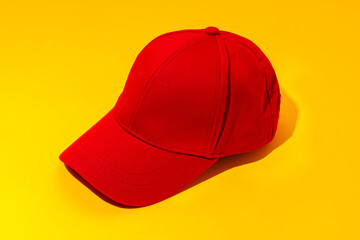 Baseball hat against yellow background in studio