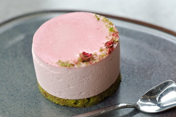 close up pink round cake on grey plate