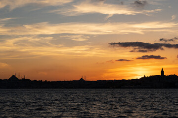 Naklejka premium Colorful orange evening sky over the city of Istanbul with Bosphorus Sea and Ayasofia
