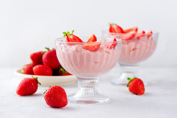 Whipped tofu and strawberry mousse dessert in a glass on a table. Vegan food. Lactose and sugar free.