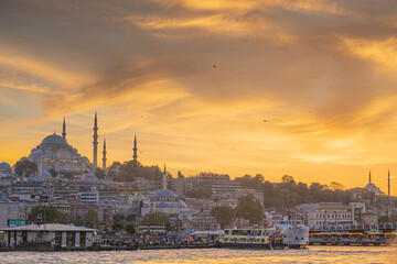 Naklejka premium Colorful orange evening sky over the city of Istanbul with Bosphorus Sea and Ayasofia