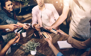 Hands, credit card and friends at cafe for payment, online transaction or pos machine. Waiter, people or debit at restaurant service with group together for finance, banking or share bill in top view