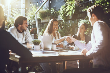 Handshake, partnership and group of people at coffee shop with agreement by contract for business meeting. Shaking hands, trust and welcome with employee for recruitment or deal by collaboration