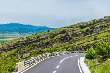 A view towards a bend in the road in the Gjere mountains close to Gjirokaster, Albania in summertime