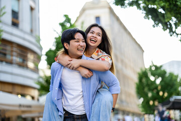 Happy young couple on city street 
