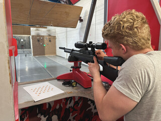 Rear view shot of a man shooting air rifle