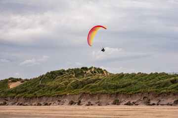 Paragliders flying above Donabate beach in Ireland, close to Dublin City.