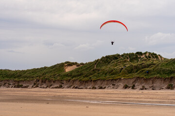 Paragliders flying above Donabate beach in Ireland, close to Dublin City.