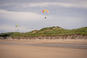 Paragliders flying above Donabate beach in Ireland, close to Dublin City.