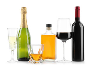 Bottles and glasses with different alcoholic drinks isolated on white