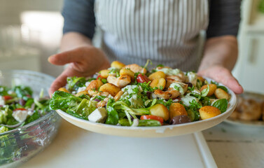 Homemade food  with a delicious and healthy salad with chicken breast, gnocchi, salad and vegetables on a plate