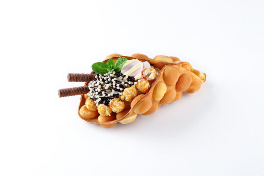 Delicious sweet bubble waffle on white background