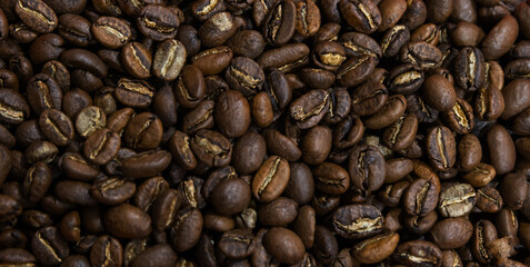Roasted coffee beans close-up, top view, background photo texture