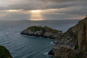 Fototapeta premium Sun beams around South Stack Lighthouse