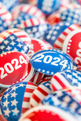 Obraz premium Pile of 2024 campaign buttons with red white and blue American flag designs