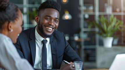 Smiling young businessman in a lively discussion with a colleague