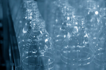 The  empty drinking water bottles  on the conveyor belt for filling process.