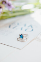 sapphire and diamond rings on a wedding invitation 