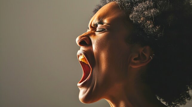 Close-up of a person shouting with intense emotion, highlighting facial expressions and raw human feelings. This image is perfect for conveying concepts of anger, frustration, 