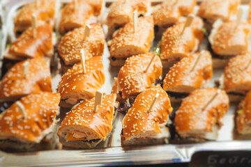 Beautifully decorated banquet catering table, with variety of with different food snacks appetizers on corporate birthday party event or wedding celebration, canape, salad, delicatessen setting