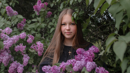 Girl among flowering trees on a walk