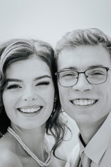 Valmiera, Latvia - September 9, 2023 - Close-up of a smiling bride and groom, capturing their happiness and joy on their wedding day. Black and white image.