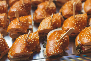 Beautifully decorated banquet catering table, with variety of with different food snacks appetizers on corporate birthday party event or wedding celebration, canape, salad, delicatessen setting