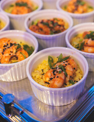 Beautifully decorated banquet catering table, with variety of with different food snacks appetizers on corporate birthday party event or wedding celebration, canape, salad, delicatessen setting