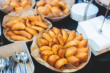Beautifully decorated banquet catering table, with variety of with different food snacks appetizers on corporate birthday party event or wedding celebration, canape, salad, delicatessen setting