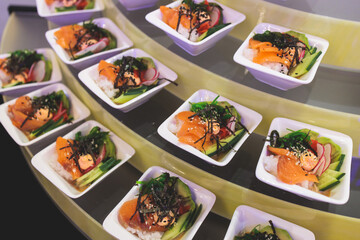 Beautifully decorated banquet catering table, with variety of with different food snacks appetizers on corporate birthday party event or wedding celebration, canape, salad, delicatessen setting
