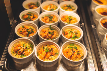 Beautifully decorated banquet catering table, with variety of with different food snacks appetizers on corporate birthday party event or wedding celebration, canape, salad, delicatessen setting