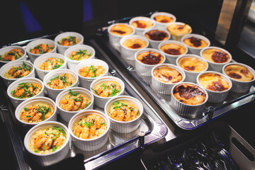 Beautifully decorated banquet catering table, with variety of with different food snacks appetizers on corporate birthday party event or wedding celebration, canape, salad, delicatessen setting