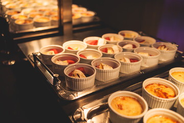 Beautifully decorated banquet catering table, with variety of with different food snacks appetizers on corporate birthday party event or wedding celebration, canape, salad, delicatessen setting