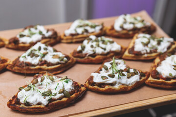 Beautifully decorated banquet catering table, with variety of with different food snacks appetizers on corporate birthday party event or wedding celebration, canape, salad, delicatessen setting