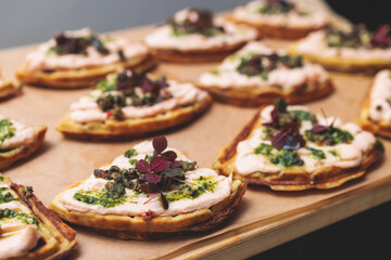 Beautifully decorated banquet catering table, with variety of with different food snacks appetizers on corporate birthday party event or wedding celebration, canape, salad, delicatessen setting